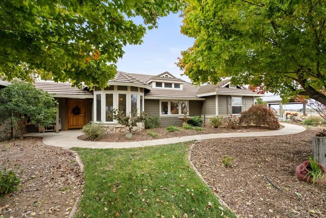 a front view of a house with yard porch and outdoor seating