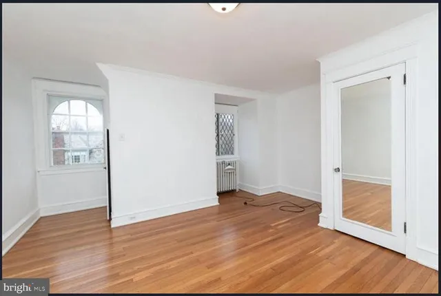 wooden floor in an empty room with a window
