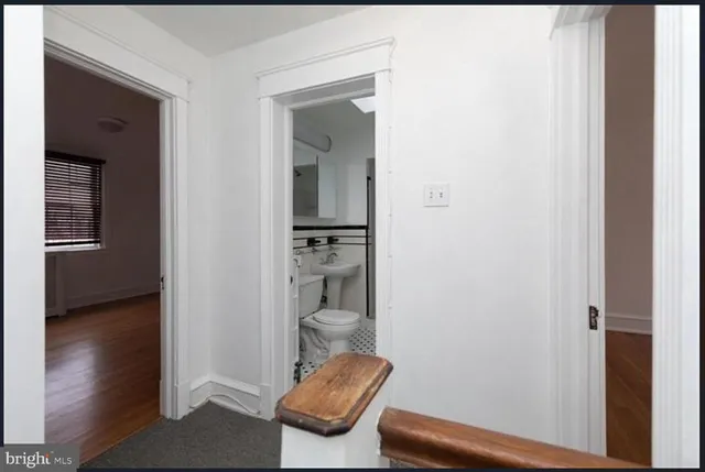 a view of hallway with furniture and wooden floor