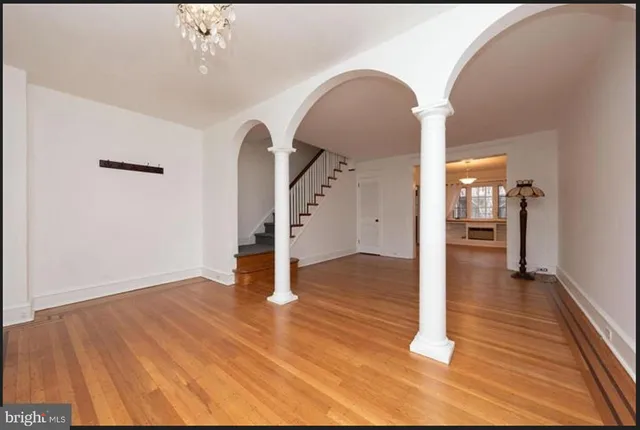 a view of a room with wooden floor and entryway