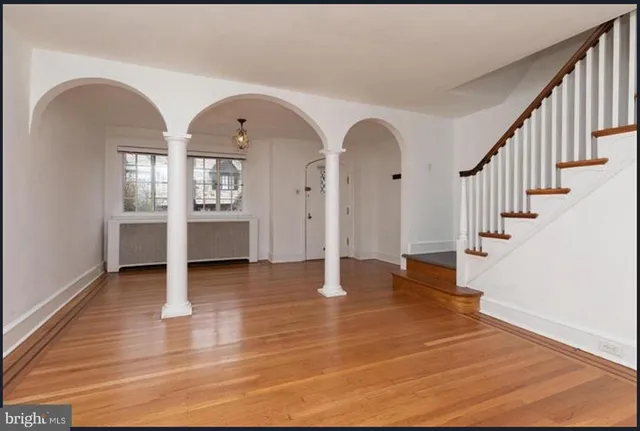 a view of entryway and hall with wooden floor