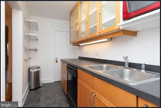 a kitchen with stainless steel appliances granite countertop a sink and a refrigerator