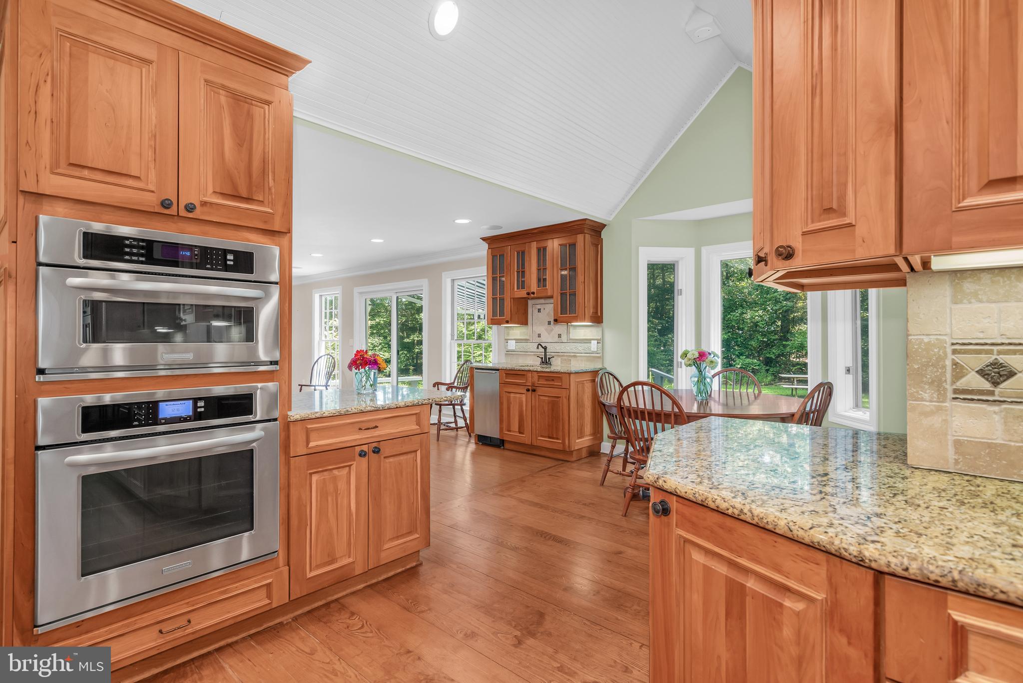 24420 Mallard Place St. Michaels, MD 21663 - Photo 16 of 33 a kitchen with stainless steel appliances granite countertop a stove a sink and a microwave