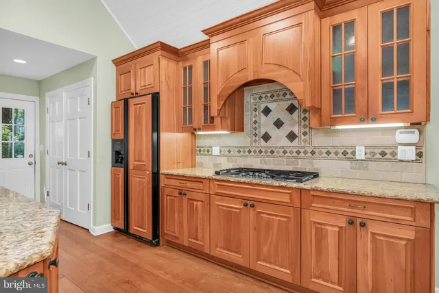 a view of a kitchen with granite countertop a sink and a stove