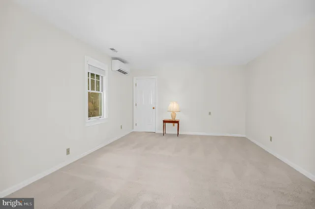 an empty room with windows and cabinet