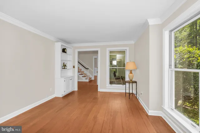 wooden floor in an empty room with a window