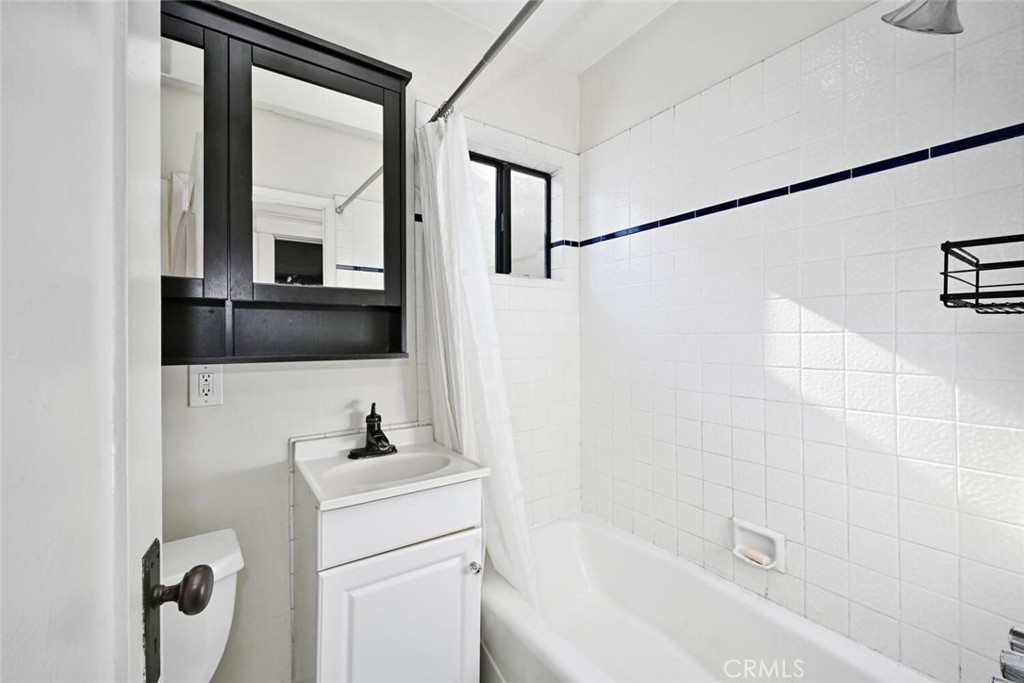 3754 Brayton Avenue Long Beach, CA 90807 - Photo 23 of 33 a bathroom with a sink a toilet and shower a mirror