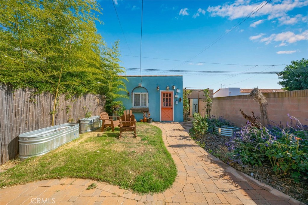 3754 Brayton Avenue Long Beach, CA 90807 - Photo 31 of 33 a view of a patio with table and chairs potted plants and large tree