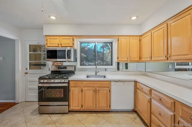a kitchen with a stove a sink and a microwave