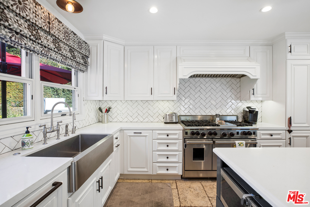 a kitchen that has a sink and a stove