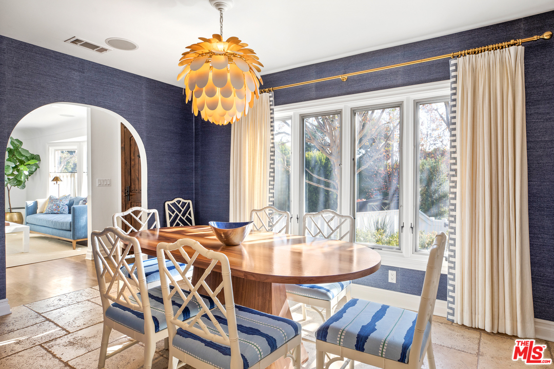 384 Dalkeith Avenue Los Angeles, CA 90049 - Photo 12 of 37 a dining room with furniture potted plants and wooden floor