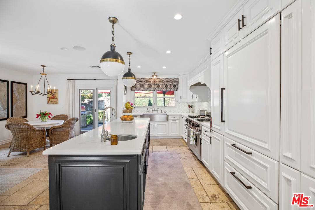 384 Dalkeith Avenue Los Angeles, CA 90049 - Photo 15 of 37 a kitchen with a sink appliances and cabinets