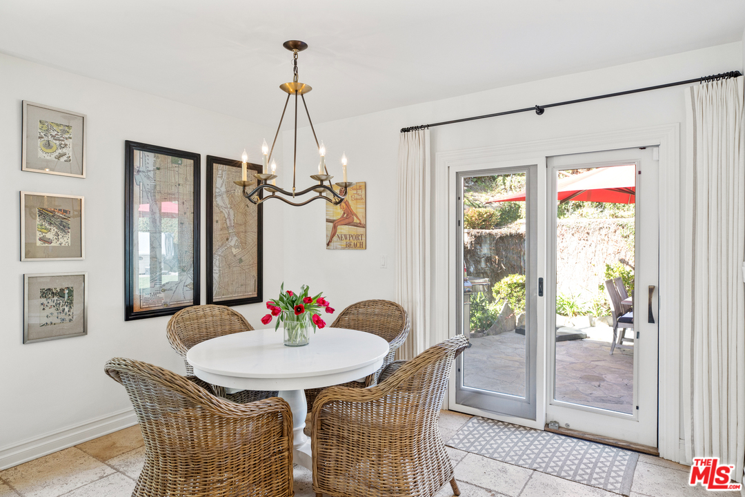 384 Dalkeith Avenue Los Angeles, CA 90049 - Photo 17 of 37 a dining room with furniture a chandelier and wooden floor