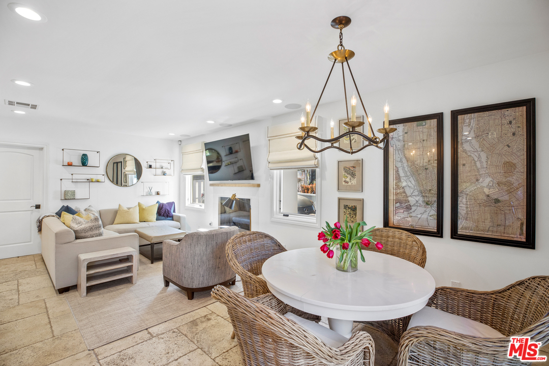 384 Dalkeith Avenue Los Angeles, CA 90049 - Photo 18 of 37 a living room with furniture a table and a chandelier