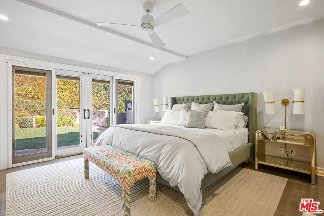 384 Dalkeith Avenue Los Angeles, CA 90049 - Photo 27 of 37 a bedroom with a bed and large window