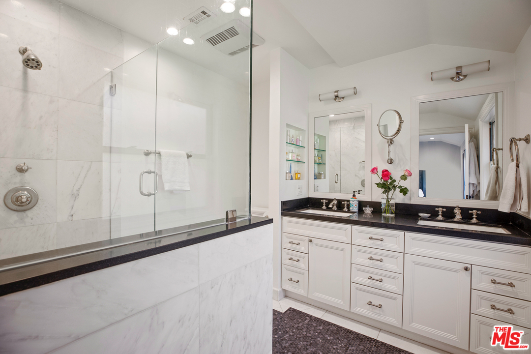384 Dalkeith Avenue Los Angeles, CA 90049 - Photo 30 of 37 a bathroom with a double vanity sink mirror and shower