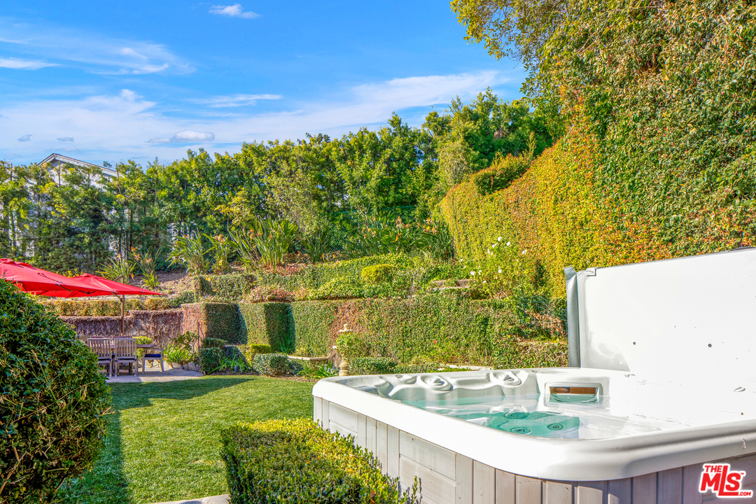 384 Dalkeith Avenue Los Angeles, CA 90049 - Photo 34 of 37 a view of yard with swimming pool and green space