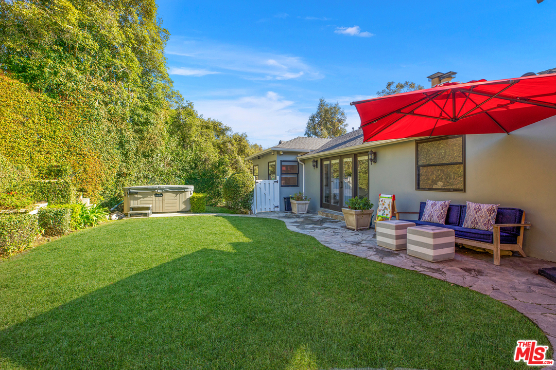 384 Dalkeith Avenue Los Angeles, CA 90049 - Photo 37 of 37 a view of a house with backyard sitting area and garden