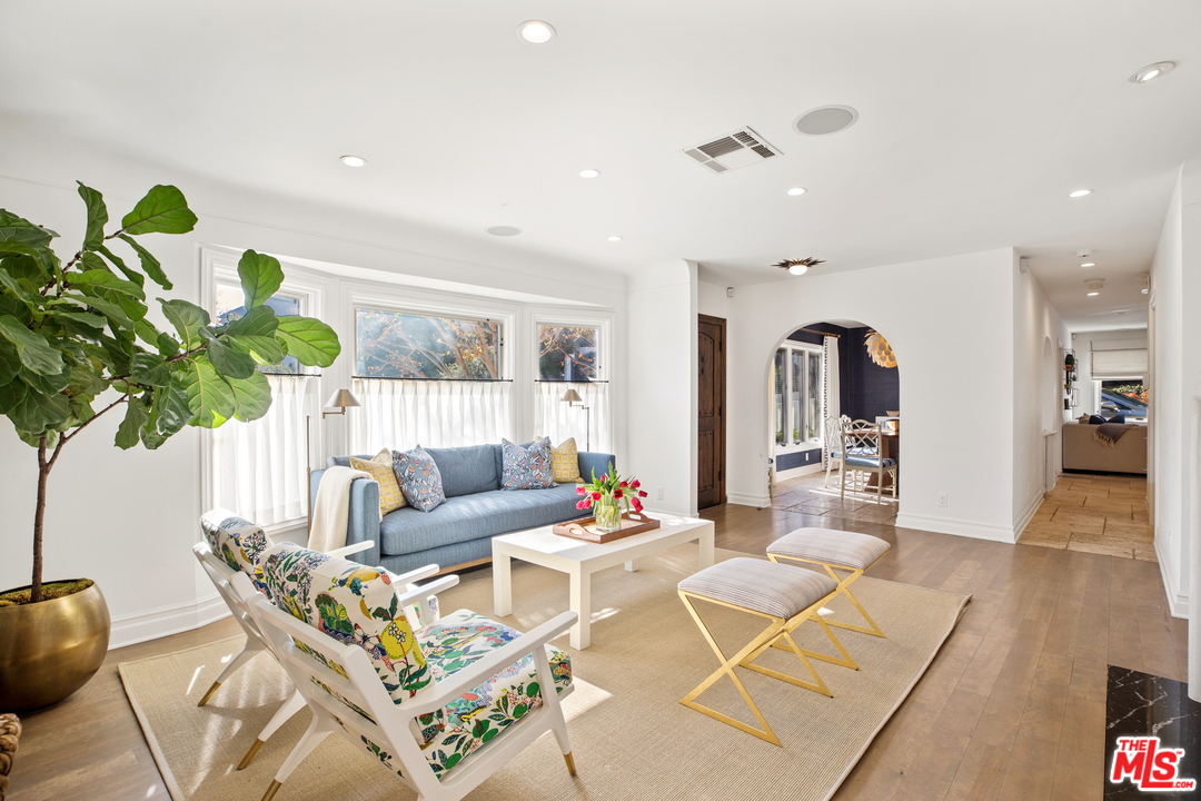 384 Dalkeith Avenue Los Angeles, CA 90049 - Photo 6 of 37 a living room with furniture flowers and a chandelier