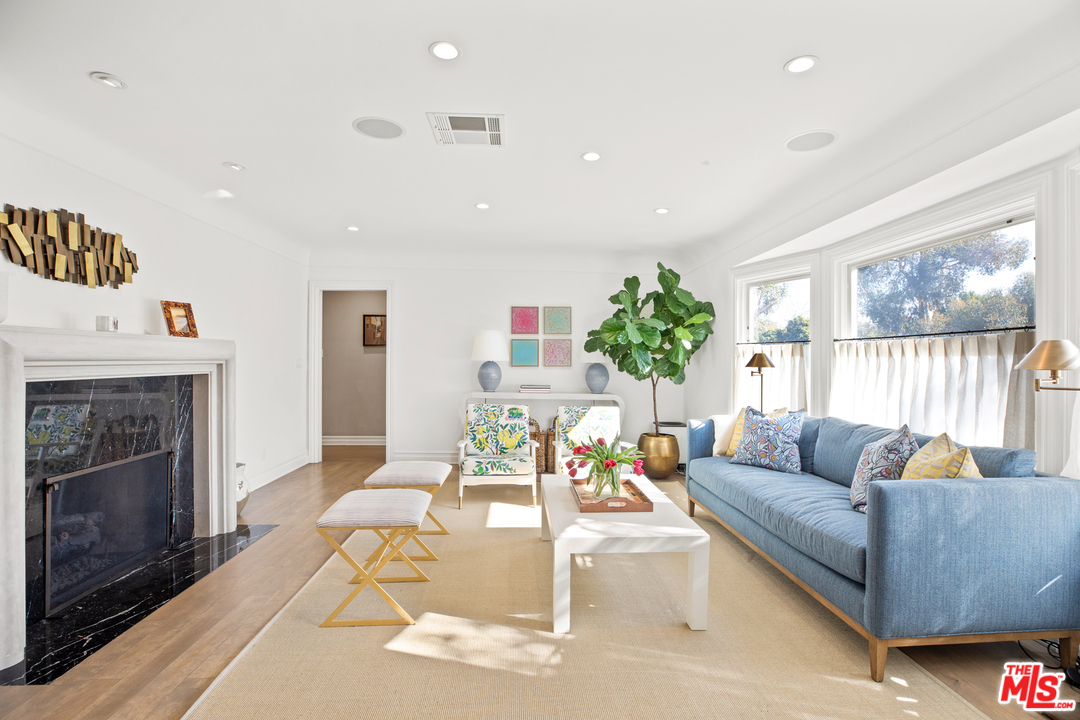 384 Dalkeith Avenue Los Angeles, CA 90049 - Photo 7 of 37 a living room with furniture fireplace and a large window