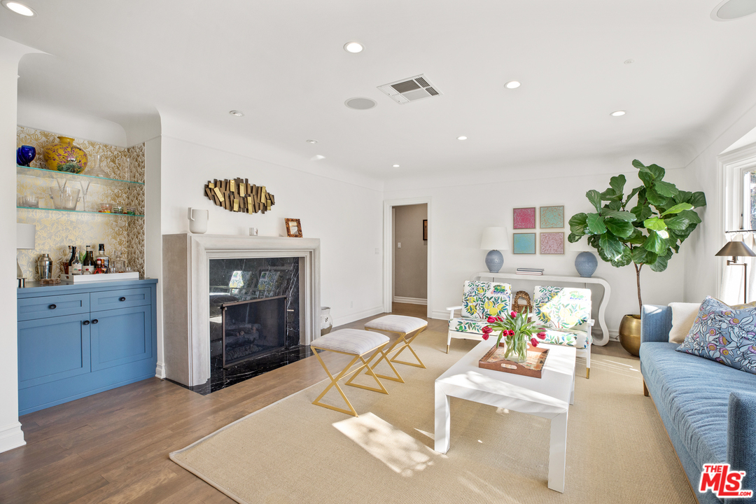 384 Dalkeith Avenue Los Angeles, CA 90049 - Photo 8 of 37 a living room with furniture and a fireplace