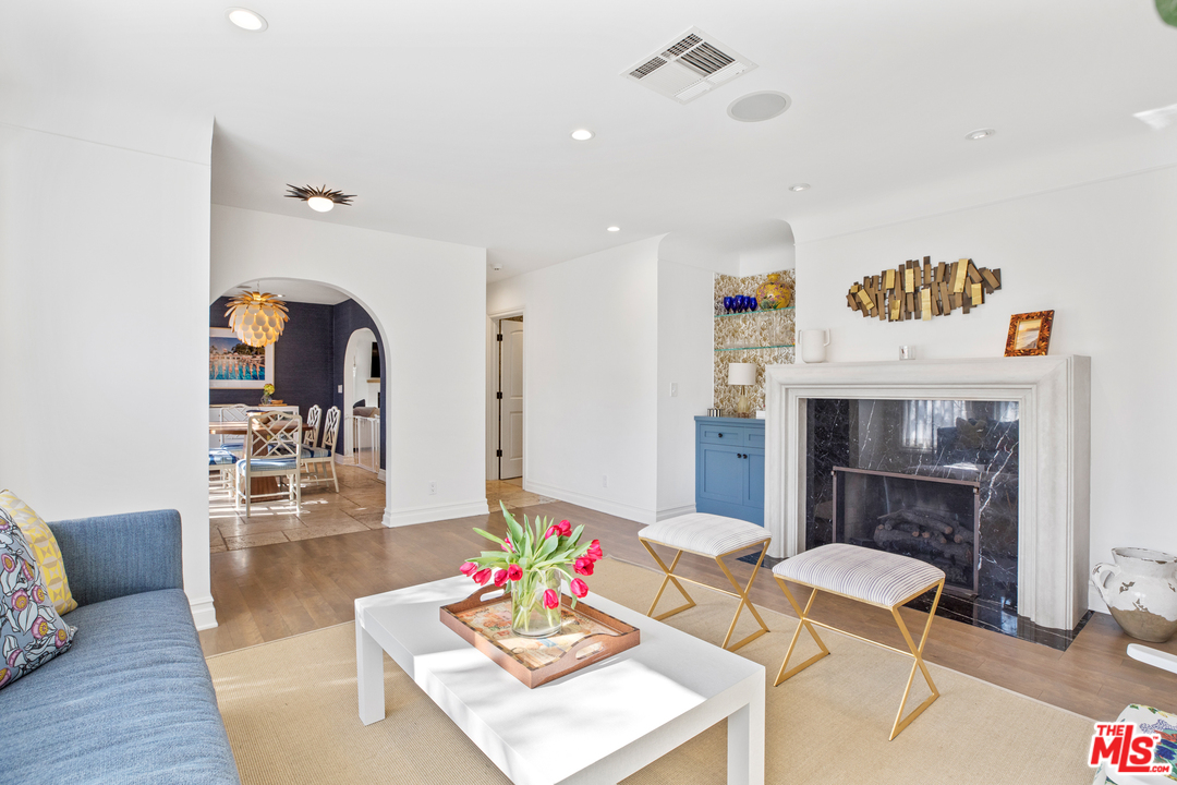 384 Dalkeith Avenue Los Angeles, CA 90049 - Photo 10 of 37 a living room with furniture and a fireplace