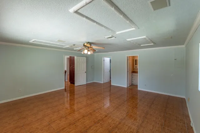a view of an empty room with wooden floor