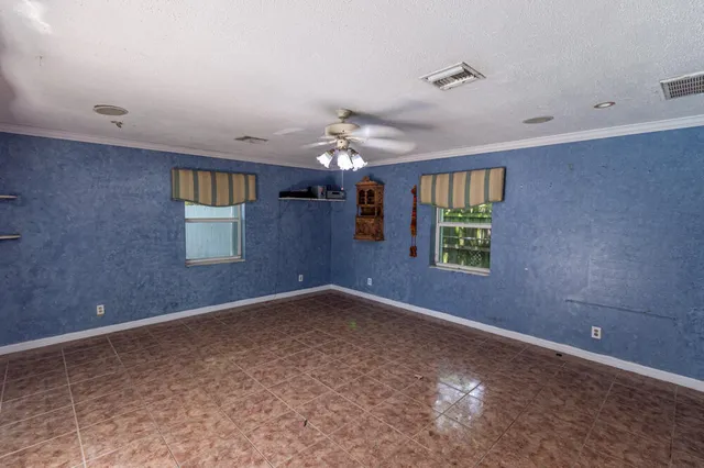 a view of a livingroom with a ceiling fan and window