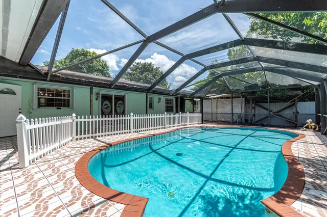 a backyard of a house with deck and outdoor seating