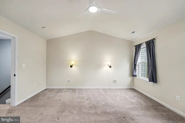 an empty room with closet and a fireplace