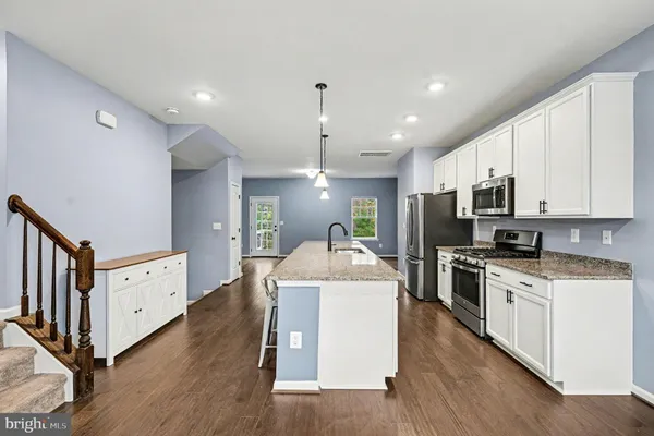 a kitchen with cabinets a sink and a stove