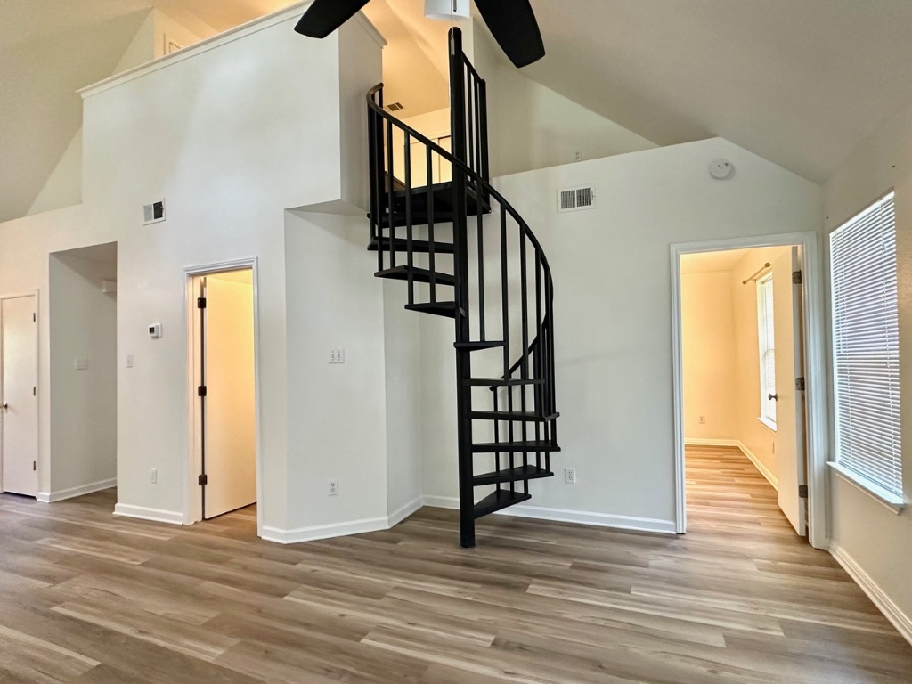 a view of an entryway with wooden floor and door