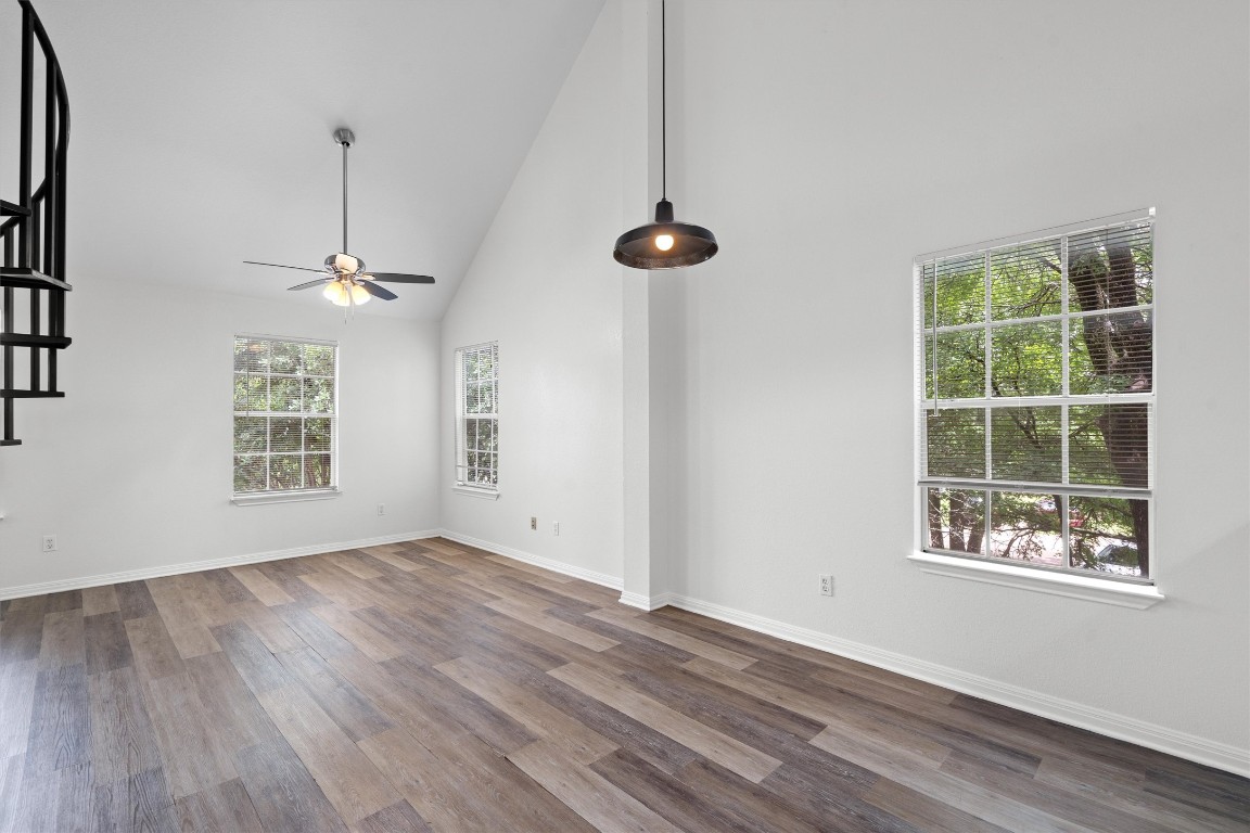 2908 Whisper Oaks Lane, Unit C Georgetown, TX 78628 - Photo 11 of 31 a view of an empty room with a window and wooden floor