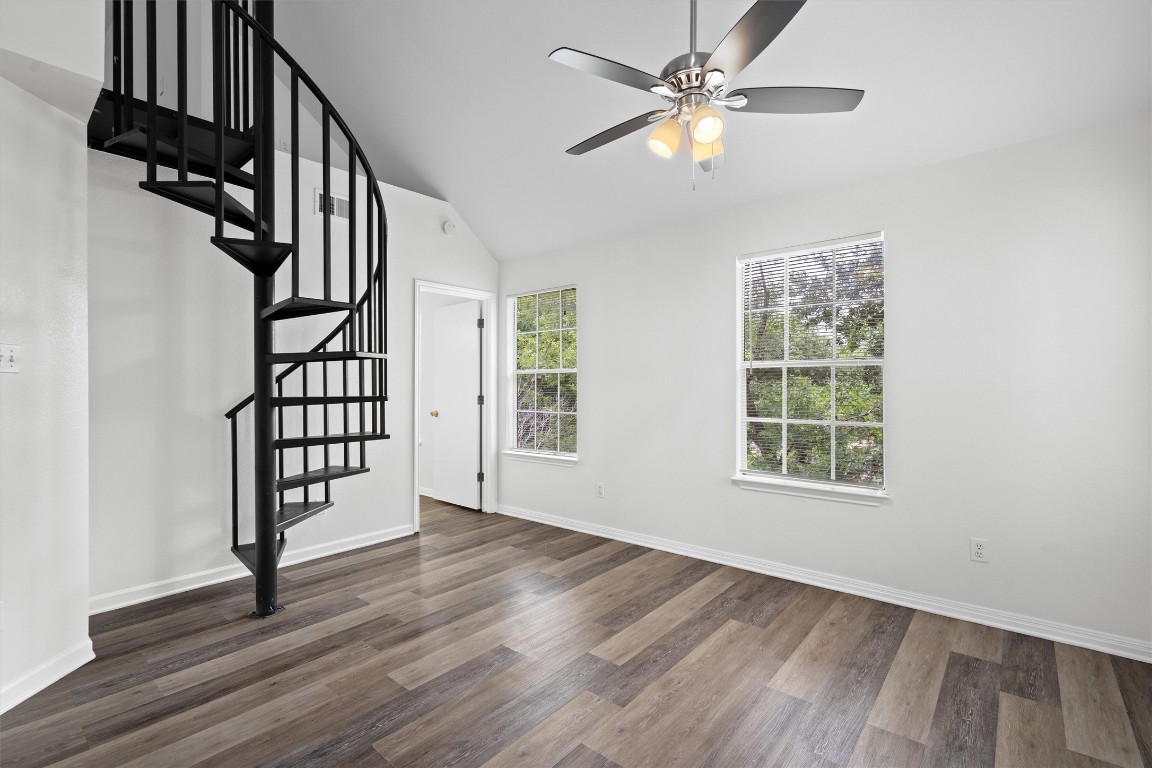 2908 Whisper Oaks Lane, Unit C Georgetown, TX 78628 - Photo 12 of 31 an empty room with wooden floor fan and windows