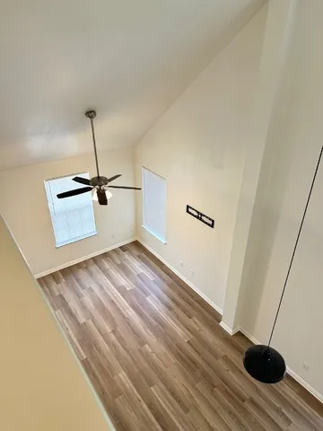 a view of a room with wooden floor