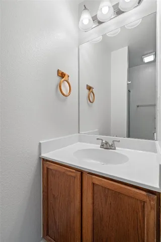 a bathroom with a sink a vanity and mirror