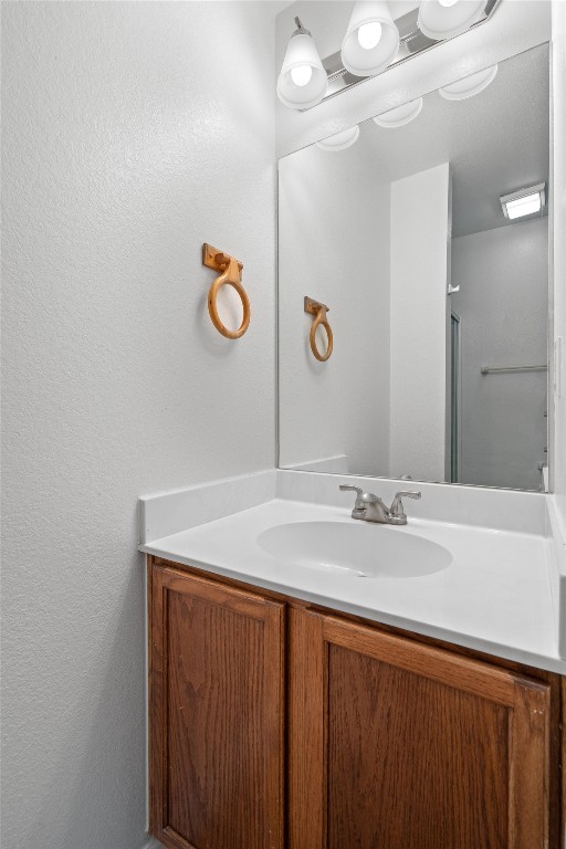2908 Whisper Oaks Lane, Unit C Georgetown, TX 78628 - Photo 20 of 31 a bathroom with a sink a vanity and mirror