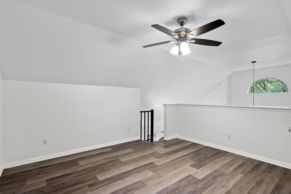 2908 Whisper Oaks Lane, Unit C Georgetown, TX 78628 - Photo 28 of 31 a view of a room with wooden floor and a ceiling fan