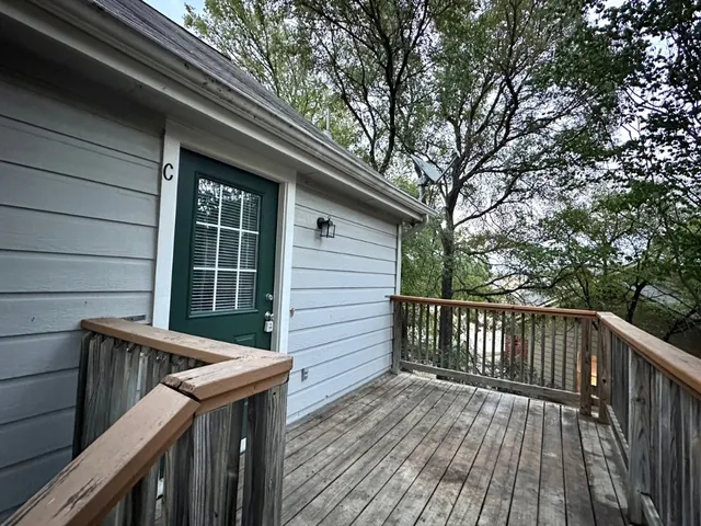 a view of deck with wooden floor and fence and trees