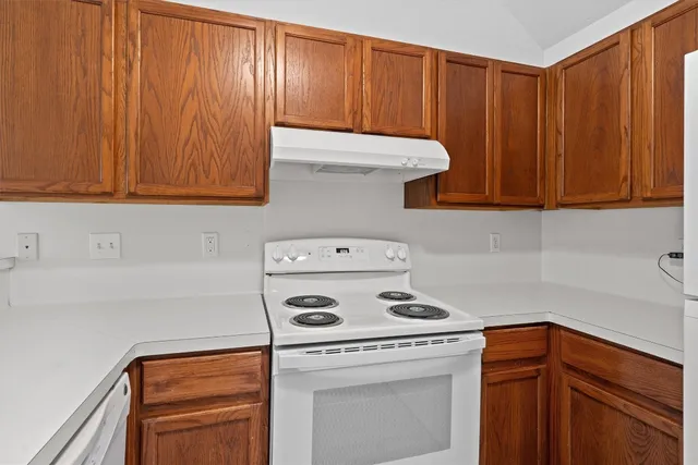 a kitchen with a stove and cabinets