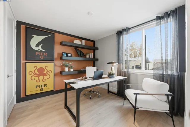 a work room with furniture and a large window