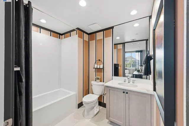 a bathroom with a double vanity sink mirror bathtub and next to a window