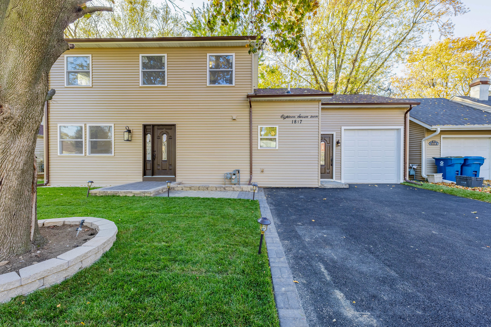 a view of a house with yard and a tree