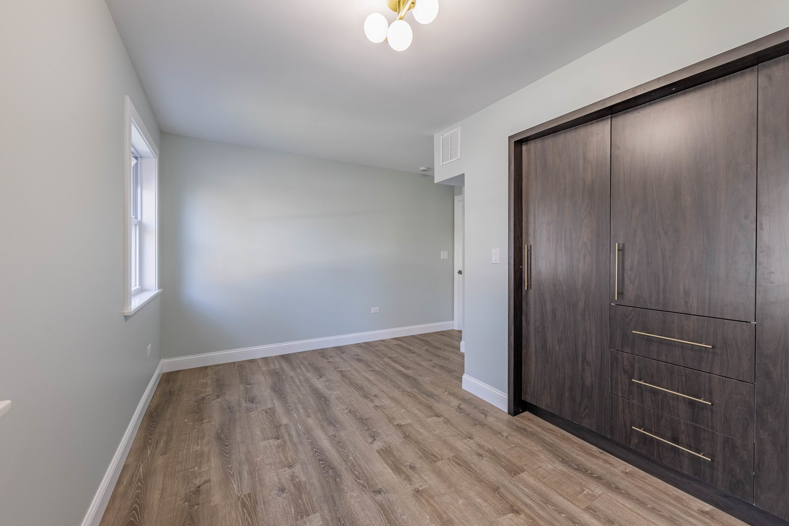 1817 Kelly Avenue Crest Hill, IL 60403 - Photo 17 of 22 an empty room with wooden floor and windows
