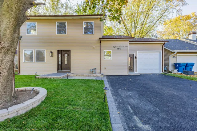 a view of a house with yard and a tree