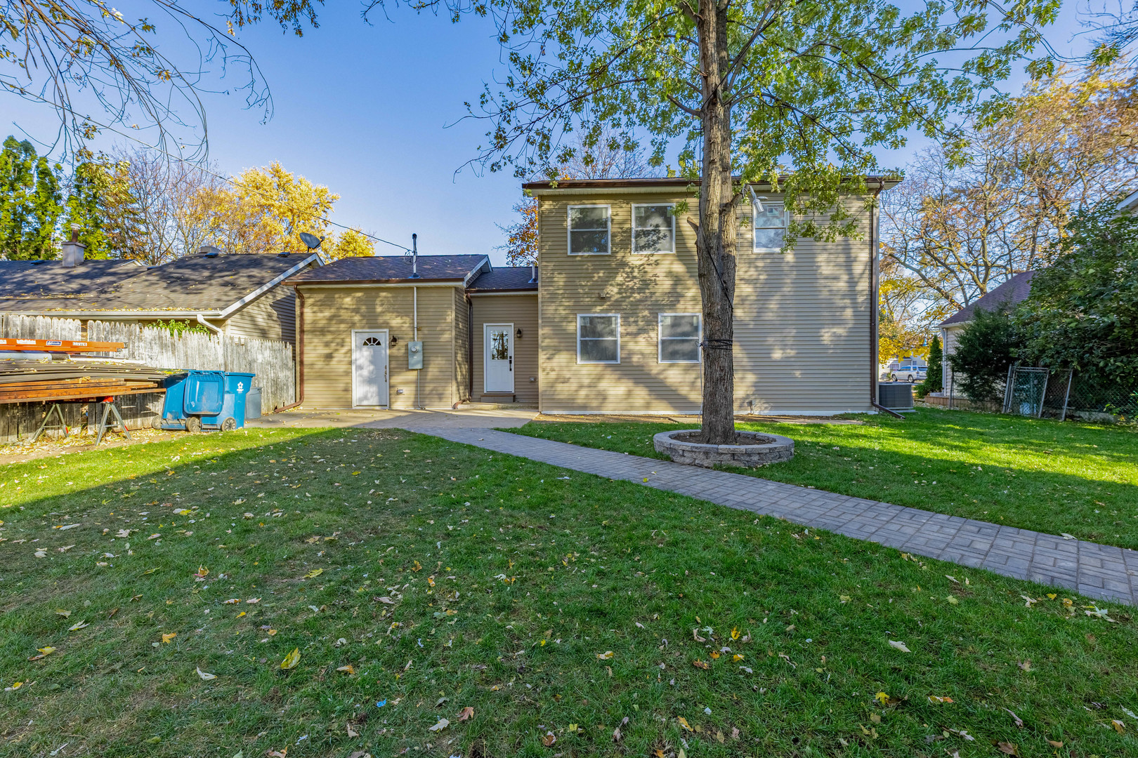 1817 Kelly Avenue Crest Hill, IL 60403 - Photo 21 of 22 a view of a house with brick walls and a yard with potted plants