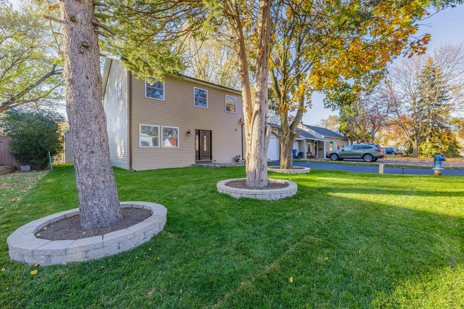 1817 Kelly Avenue Crest Hill, IL 60403 - Photo 22 of 22 a front view of a house with garden and trees
