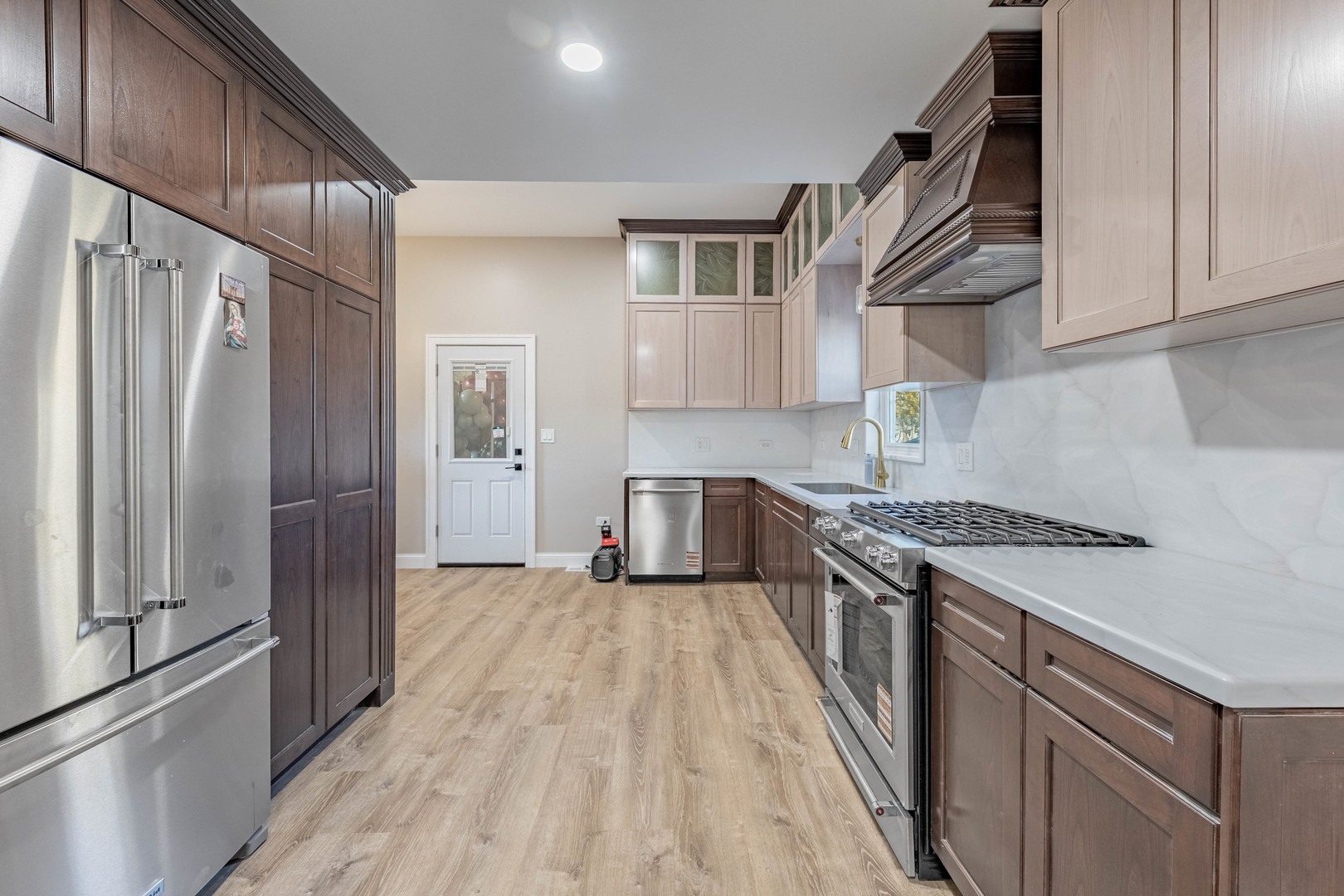 1817 Kelly Avenue Crest Hill, IL 60403 - Photo 7 of 22 a kitchen with stainless steel appliances granite countertop a refrigerator a sink and wooden cabinets