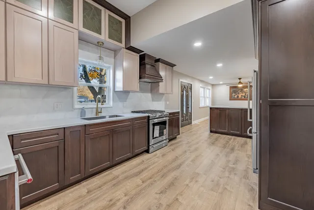 a kitchen with stainless steel appliances granite countertop a stove a sink and a refrigerator