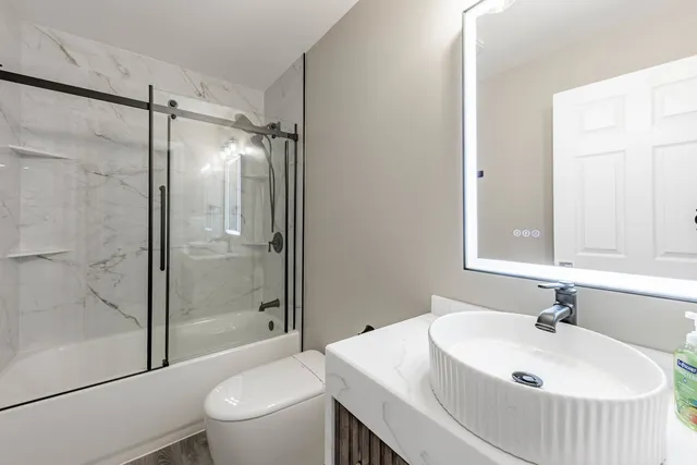 a bathroom with a sink toilet and shower